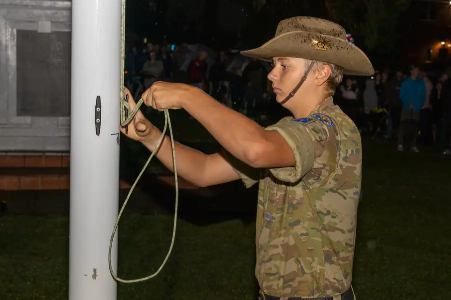 An Army cadet tends the flag during the ANZAC Day service.
