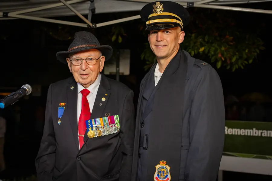 A veteran alongside a serving naval officer at the service.