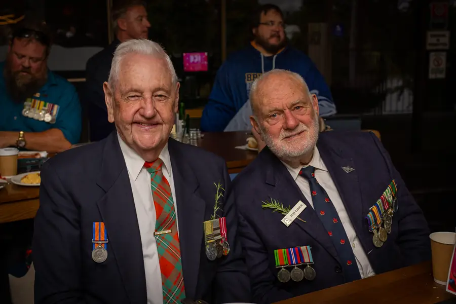 Two veterans wearing their service medals.