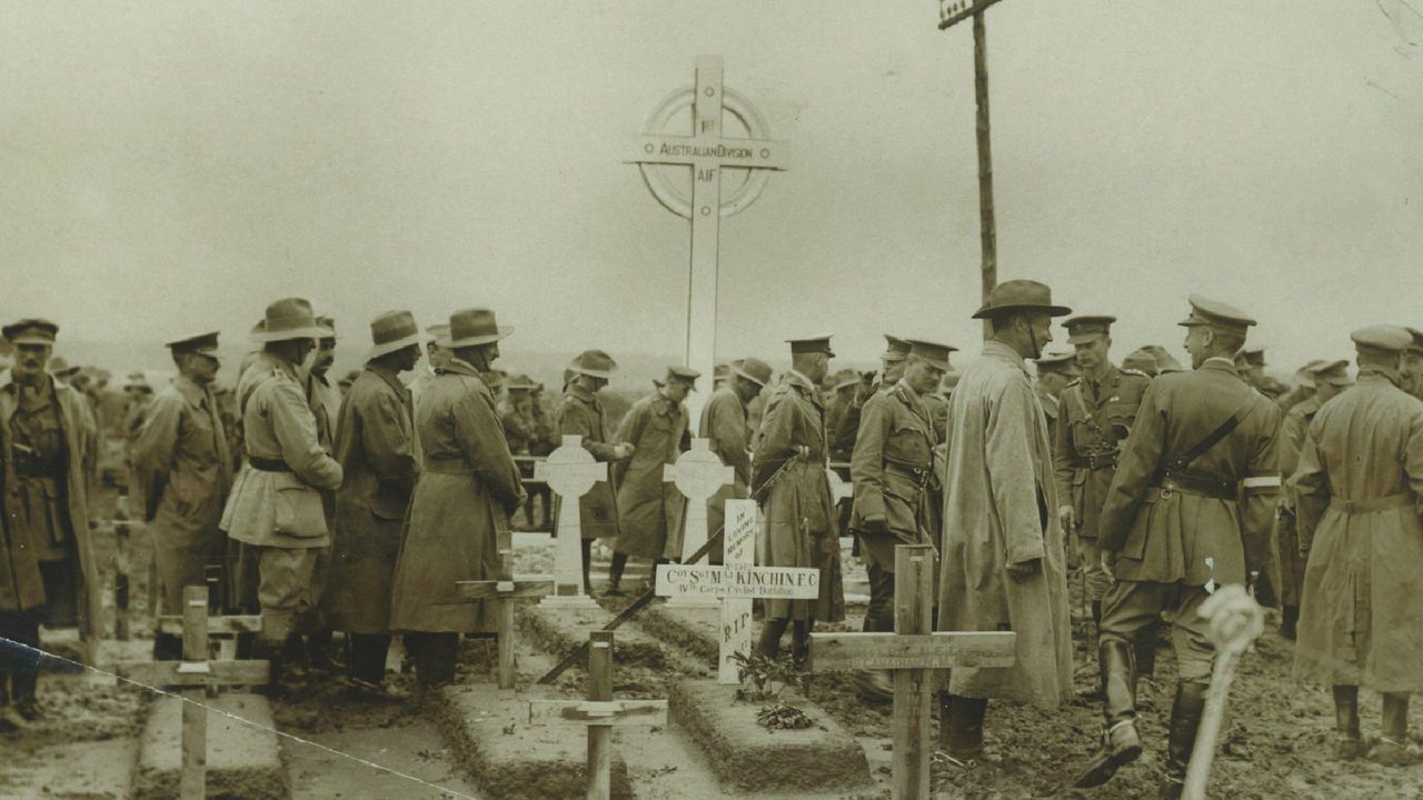 Australian soldiers gathered at a 1st Australian Division AIF war cemetery on the Western Front.